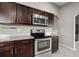 Kitchen showcasing stainless steel stove/oven with dark cabinets, complemented by stylish granite countertops at 5707 Fischer Dr, Lakeland, FL 33812