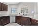 Corner kitchen sink with granite countertops and stainless steel dishwasher, providing modern convenience and style at 5707 Fischer Dr, Lakeland, FL 33812