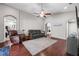Comfortable living room with vaulted ceiling, modern fan, and rich dark wood floors at 5707 Fischer Dr, Lakeland, FL 33812