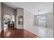 Open-concept living area features hardwood floors and seamlessly connects to tiled dining area with large window at 5707 Fischer Dr, Lakeland, FL 33812