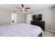 Bright main bedroom featuring ceiling fan, window, and private ensuite access at 5707 Fischer Dr, Lakeland, FL 33812