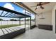 Screened patio with ceiling fan, lights and outdoor seating area overlooking fenced backyard at 5707 Fischer Dr, Lakeland, FL 33812
