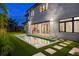 Backyard oasis with a sparkling pool, lush grass, and a covered patio with an outdoor kitchen at 5762 Emerington Cres, Orlando, FL 32819