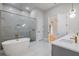Bright bathroom featuring a soaking tub, walk-in shower, and modern fixtures at 5762 Emerington Cres, Orlando, FL 32819