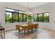 Elegant dining room featuring large windows and a modern chandelier at 5762 Emerington Cres, Orlando, FL 32819