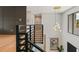 Bright entryway with modern chandelier, dark paneled accent wall, and black railing staircase with light wood flooring at 5762 Emerington Cres, Orlando, FL 32819