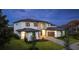 Beautiful modern home features a manicured lawn and brick driveway leading to a large garage at 5762 Emerington Cres, Orlando, FL 32819
