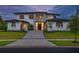 Stunning two-story home featuring a modern design with a paver driveway, manicured lawn and sophisticated front entrance at 5762 Emerington Cres, Orlando, FL 32819