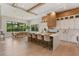 Open-concept kitchen with a large island, dining area, and views of the lush backyard at 5762 Emerington Cres, Orlando, FL 32819