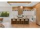Modern kitchen featuring an island with seating, white cabinetry, hardwood floors, and contemporary fixtures for cooking at 5762 Emerington Cres, Orlando, FL 32819