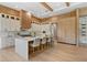 Bright, modern kitchen featuring a large island with seating, custom cabinetry, and a built-in wine rack at 5762 Emerington Cres, Orlando, FL 32819