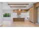 Bright, modern kitchen with wood and white cabinets, an island, and wood flooring at 5762 Emerington Cres, Orlando, FL 32819
