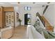 Bright living room with hardwood floors, high ceilings, modern staircase, and a view to the home's exterior at 5762 Emerington Cres, Orlando, FL 32819