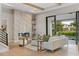 Cozy living room with a marble fireplace, hardwood floors, modern furniture, and a seamless transition to the outdoor area at 5762 Emerington Cres, Orlando, FL 32819