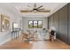 Bright living room with tray ceilings, stylish furnishings, hardwood floors and large windows with a view of the neighborhood at 5762 Emerington Cres, Orlando, FL 32819