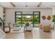 Open-concept living room featuring hardwood floors, comfortable seating, and sliding glass doors to the outdoor pool area at 5762 Emerington Cres, Orlando, FL 32819