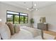 Comfortable main bedroom featuring a large window with backyard views and neutral decor at 5762 Emerington Cres, Orlando, FL 32819