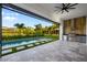 Outdoor kitchen with built-in grill and views of the sparkling swimming pool at 5762 Emerington Cres, Orlando, FL 32819