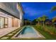Backyard pool featuring modern design, stone pavers, and lush landscaping, perfect for relaxation and outdoor enjoyment at 5762 Emerington Cres, Orlando, FL 32819
