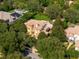 Expansive aerial view of a luxurious home featuring a tile roof, pool, and lush landscaping at 6143 Cartmel Ln, Windermere, FL 34786