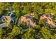 Expansive aerial view of a home with lush surroundings, a circular driveway, and a backyard pool at 6143 Cartmel Ln, Windermere, FL 34786