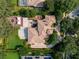 Expansive aerial view of a home with pool, manicured landscaping, and tile roof at 6143 Cartmel Ln, Windermere, FL 34786