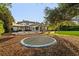 Lush backyard with mature trees, a trampoline, and sun shades create a peaceful outdoor retreat at 6143 Cartmel Ln, Windermere, FL 34786