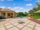 Expansive backyard featuring a covered patio, fire pit, pool and slide for the perfect outdoor oasis at 6143 Cartmel Ln, Windermere, FL 34786