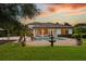 Inviting backyard pool with water feature, covered patio, and lush landscaping at 6143 Cartmel Ln, Windermere, FL 34786