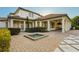 Expansive backyard featuring a covered patio, outdoor kitchen, and decorative fountain at 6143 Cartmel Ln, Windermere, FL 34786
