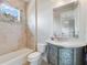 Charming bathroom featuring a unique vanity, a soaking tub, and a decorative mirror with plenty of light at 6143 Cartmel Ln, Windermere, FL 34786