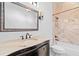 Bathroom with a marble vanity, ornate framed mirror, and bathtub with a marble tiled surround at 6143 Cartmel Ln, Windermere, FL 34786