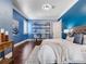 Stylish blue bedroom with hardwood floors, workstation, neutral accents, and ample natural light at 6143 Cartmel Ln, Windermere, FL 34786
