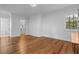 An empty bedroom with hardwood floors, natural light, and an ensuite bathroom with a walk in closet at 6143 Cartmel Ln, Windermere, FL 34786