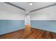 Empty bedroom with hardwood floors, wainscoting, and view of an ensuite bathroom at 6143 Cartmel Ln, Windermere, FL 34786