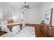 Spacious bedroom with hardwood floors, ceiling fan, ensuite, and decorative rug at 6143 Cartmel Ln, Windermere, FL 34786