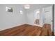 Empty bedroom with hardwood floors, natural light, and a view into the ensuite bathroom at 6143 Cartmel Ln, Windermere, FL 34786