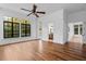 Large bonus room with hardwood floors, expansive windows, and backyard access at 6143 Cartmel Ln, Windermere, FL 34786