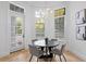 Breakfast nook with bright windows, tile floors and a modern chandelier at 6143 Cartmel Ln, Windermere, FL 34786
