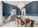 Formal dining room featuring a modern chandelier and navy-blue wallpaper at 6143 Cartmel Ln, Windermere, FL 34786
