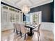 Elegant dining room with high ceilings, large windows, chandelier, and designer wallpaper at 6143 Cartmel Ln, Windermere, FL 34786