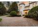 Beautiful view of the home's architectural design with unique features and a circular driveway at 6143 Cartmel Ln, Windermere, FL 34786