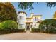 Elegant two-story home with a turret and a brick driveway provides a charming, stately appeal at 6143 Cartmel Ln, Windermere, FL 34786