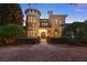 Stunning home exterior with a circular tower and manicured landscaping at 6143 Cartmel Ln, Windermere, FL 34786