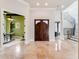 Grand foyer featuring marble floors, staircase, and a solid wood door at 6143 Cartmel Ln, Windermere, FL 34786