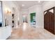 Foyer featuring arches, marble floors, and a view into other rooms of the home at 6143 Cartmel Ln, Windermere, FL 34786