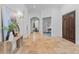 Grand foyer with arched doorways, travertine floors, and designer lighting exudes sophistication at 6143 Cartmel Ln, Windermere, FL 34786