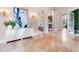 Foyer featuring arches, marble floors, and fireplace with white furniture at 6143 Cartmel Ln, Windermere, FL 34786