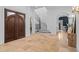 Spacious foyer features dark wood entry doors, and a decorative staircase, adding a touch of elegance at 6143 Cartmel Ln, Windermere, FL 34786