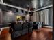 Immersive home theater with reclining chairs, dark walls, and a large screen for an exceptional viewing experience at 6143 Cartmel Ln, Windermere, FL 34786